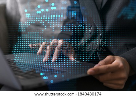 Businesswoman typing on laptop in office. Planet earth world map hologram. International business concept. Double exposure.