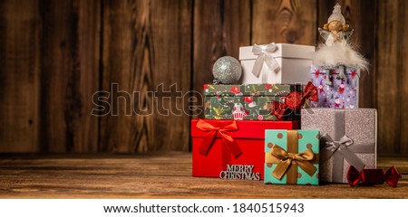 Panorama beautiful Christmas gift boxes presents on wooden background.