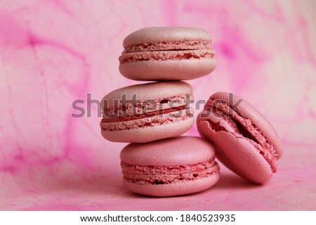 Stack of pink macarons on abstract watercolor background. Sweet food. Delicious pastries. Beautiful template with pink macaroon for wallpaper design.