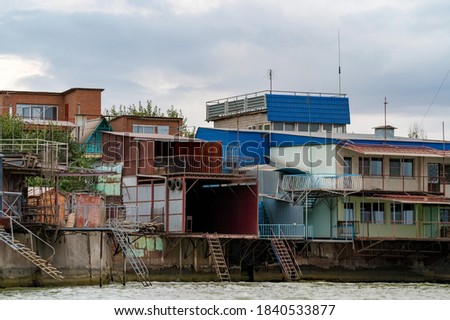Picture of old rustic wooden boat sheds with ladders