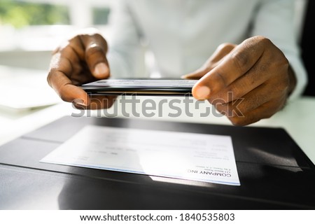 Remote Check Deposit Using Mobile Photo Scanning Royalty-Free Stock Photo #1840535803