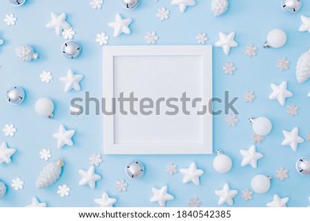 Mockup white frame with christmas decorationon a blue background