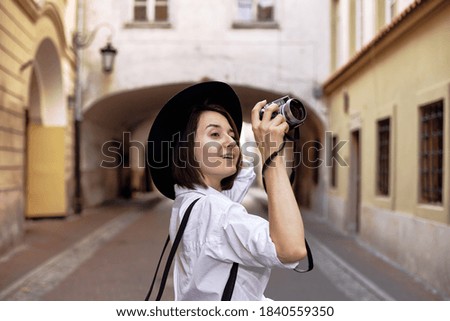 The girl in the black hat shooting in an old european town. Euro summer trip.