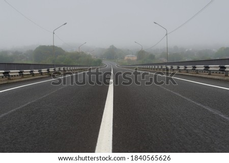 View of the center of the road with fog on the background Royalty-Free Stock Photo #1840565626