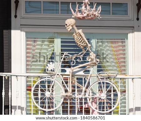 Halloween decoration, skeleton on the bicycle. Selective focus, street photo, travel photo.