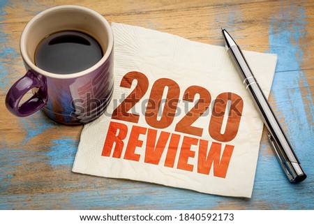 2020 year review text on a napkin with a cup of coffee, end of year business concept Royalty-Free Stock Photo #1840592173