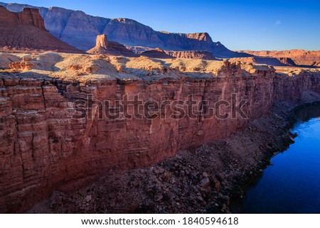 The Colorado River flows through Marble Canyon on it's way to the Grand Canyon.  The Vermillion Cliffs in the background. Royalty-Free Stock Photo #1840594618