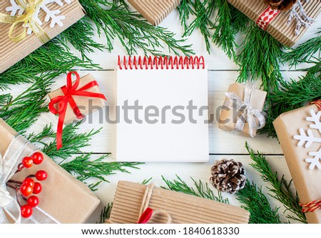 Wish list Christmas shopping, planning. Spruce branches, Christmas decorations, gifts flat lay on white background. Copyspace. New year, xmas celebration, noel