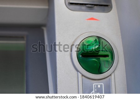 Close-up ATM card reader, green credit card reader with fraud protection. Horizontal photo of an automatic machine for withdrawing cash from a bank account