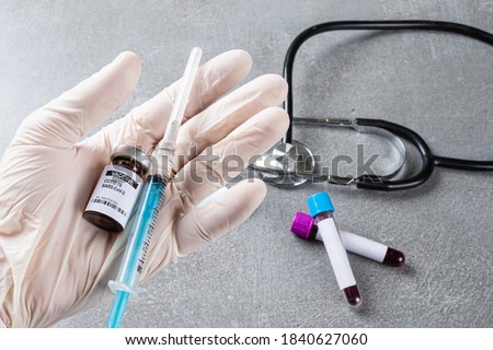 Doctor holding vaccine for Covid-19. Royalty-Free Stock Photo #1840627060