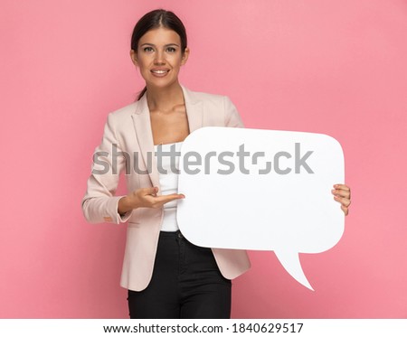 young businesswoman presenting her speech bubble on pink background