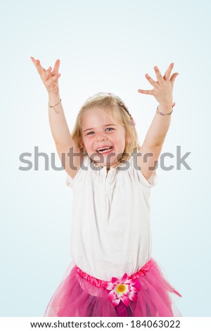 Cute and happy little girl, studio shot isolated on light sky blue background