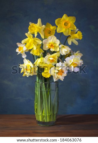 Yellow flowers in a glass vase on the table