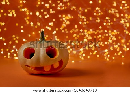 Happy Halloween Pumpkin on orange paper background. Creative Halloween minimal concept 