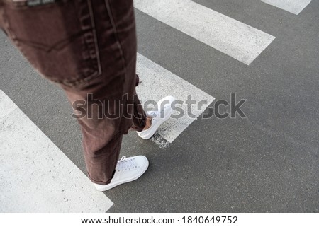 
female feet crossing the crosswalk