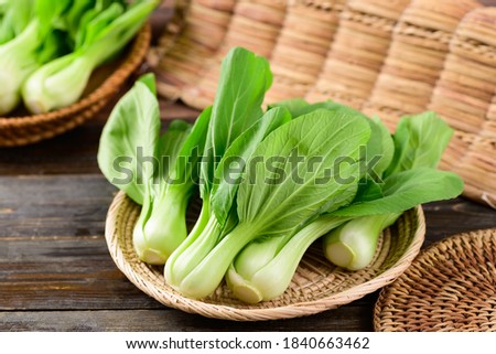 Fresh Bok Choy or Pak Choi(Chinese cabbage) in bamboo basket on wooden background, Organic vegetables Royalty-Free Stock Photo #1840663462