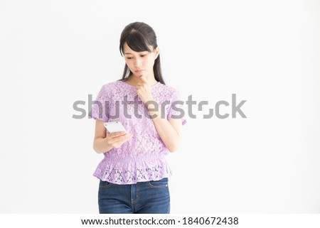 young attractive asian woman to see a smart phone,think,