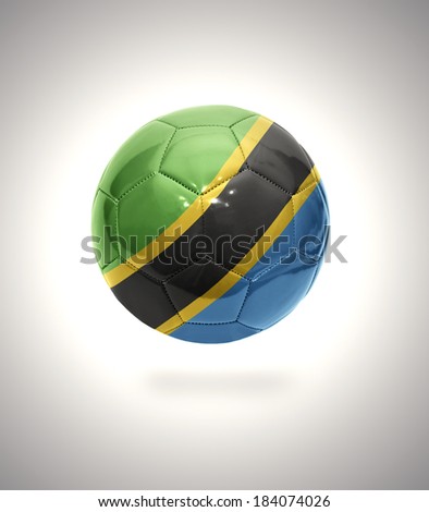 Football ball with the national flag of Tanzania on a gray background