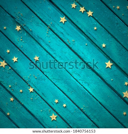 golden confetti on blue wooden background