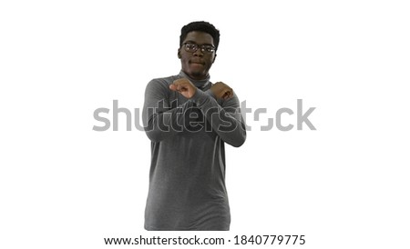 Young african american man in grey clothes and glasses grooving
