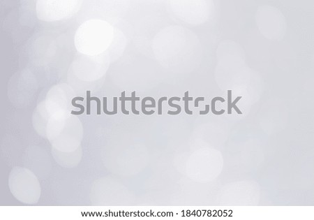 Soft White bokeh lights abstract background. Defocused bokeh on gray background.