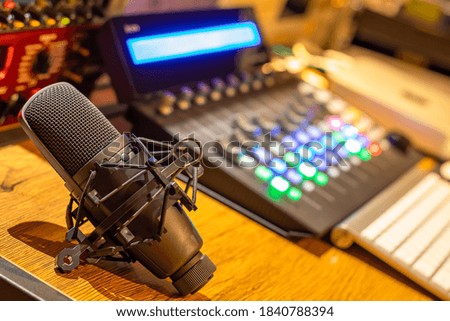 condenser microphone on broadcasting studio desk