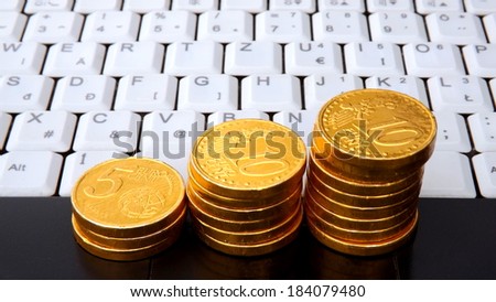 White Notebook keyboard and Gold Coins