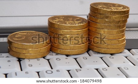 White Notebook keyboard and Gold Coins