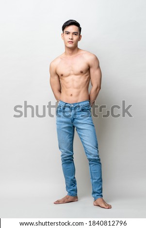 Full length portrait of muscular handsome shirtless Asian man standing and posing in light gray studio isolated background Royalty-Free Stock Photo #1840812796