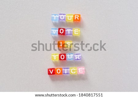 Presidental election day lettering. 2020 quote. American vote banner. Grey background. Colorful phrase. Your vote is your voice slogan