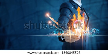 Hot business growth. Creativity of marketing, Businessman holding light bulb and analyzing sales data and economic growth graph chart. Business strategy, financial and banking. Digital marketing. 