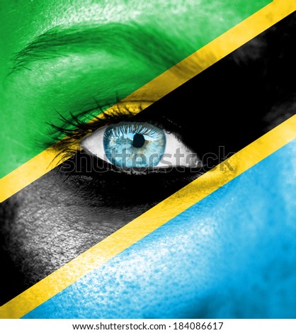 Woman face painted with flag of Tanzania