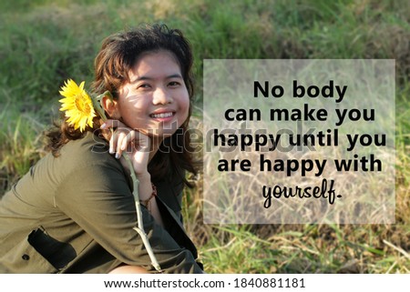 Inspirational quote - No body can make you happy until you are happy with yourself.  Self motivation words concept with happy smiling face of young woman holding sunflower in field background.