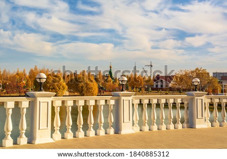 Embankment with beautiful terrace and parapet in the autumn city park Royalty-Free Stock Photo #1840885312