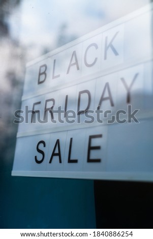 Lightbox Sign Black Friday Sale behind a glass window of the shop. Concept Black friday, season sales time.