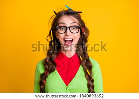 Photo of nerd teenager girl with pencil messy hairdo excited wear green clothes isolated shine color background
