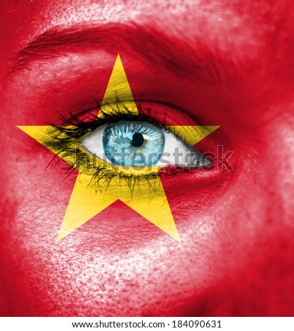 Woman face painted with flag of Vietnam