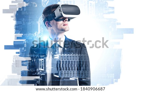 Portrait of young European businessman in VR glasses standing in blurry modern city. Concept of hi tech and virtual reality. Toned image double exposure