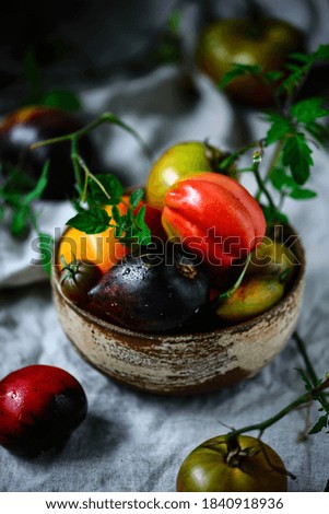 Fresh, ripe, organic tomatoes in an old basket. Rustic style.selective focus