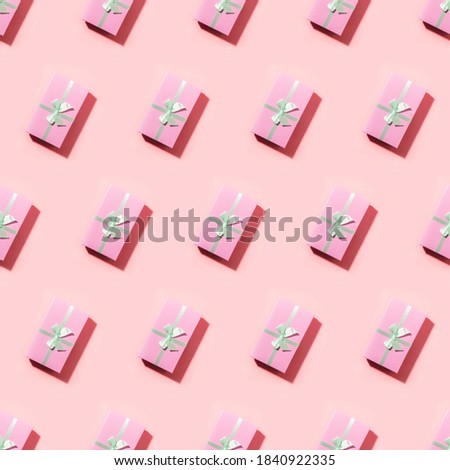 Seamless pattern of many pink gift boxes with shadow on pink.