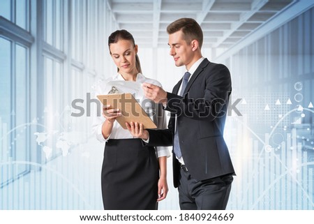 Businessman and businesswoman working together in blurry panoramic office with double exposure of network interface. Toned image
