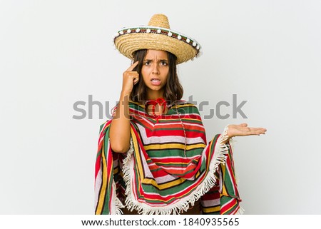 Young mexican woman isolated on white background holding and showing a product on hand.