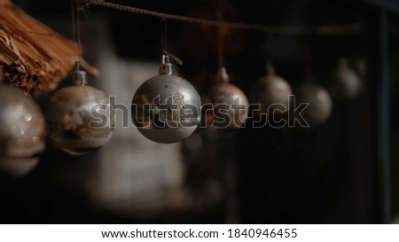 Small red Christmas toys 
ball glass hanging on glass in the house