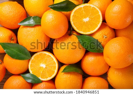 fresh orange fruits with leaves as background, top view Royalty-Free Stock Photo #1840946851