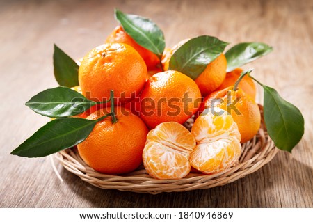 Fresh mandarin oranges fruit or tangerines with leaves on a wooden table Royalty-Free Stock Photo #1840946869