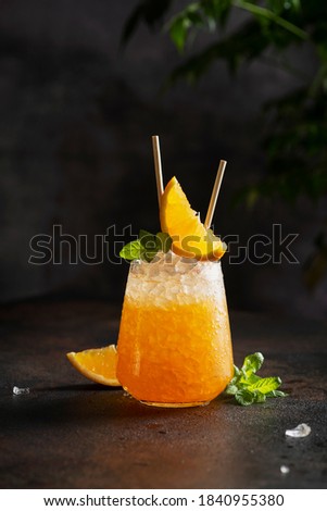 Fresh cold cocktial with orange, crushed ice and mint, selective focus image and bar concept Royalty-Free Stock Photo #1840955380