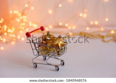 Food basket with Golden Christmas balls on the background of glowing lights. New year's sale concept