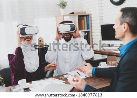 Arab couple is studying house in virtual reality glasses. Real estate services. Presentation of real estate with help of virtual reality. Royalty-Free Stock Photo #1840977613
