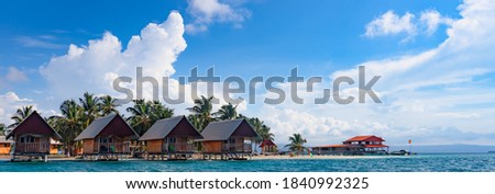 Island resort with cabins overwater, Caribbean, San Blas, Panama Royalty-Free Stock Photo #1840992325