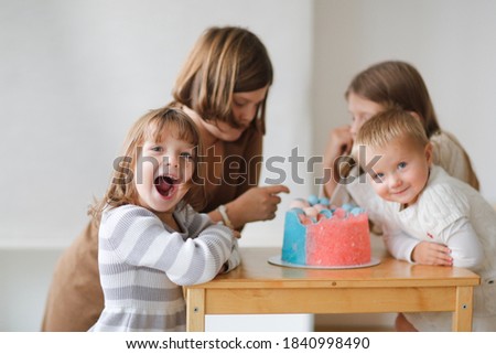 Kids at gender reveal party, cake pink and blue, boy or girl party,